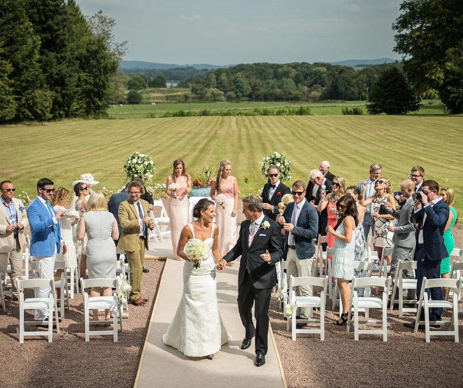 Couple walking down the aisle at their countryside wedding in the Wyndham Halcyon Retreat