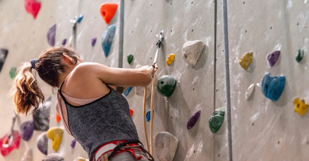girl indoor rock climbing wall